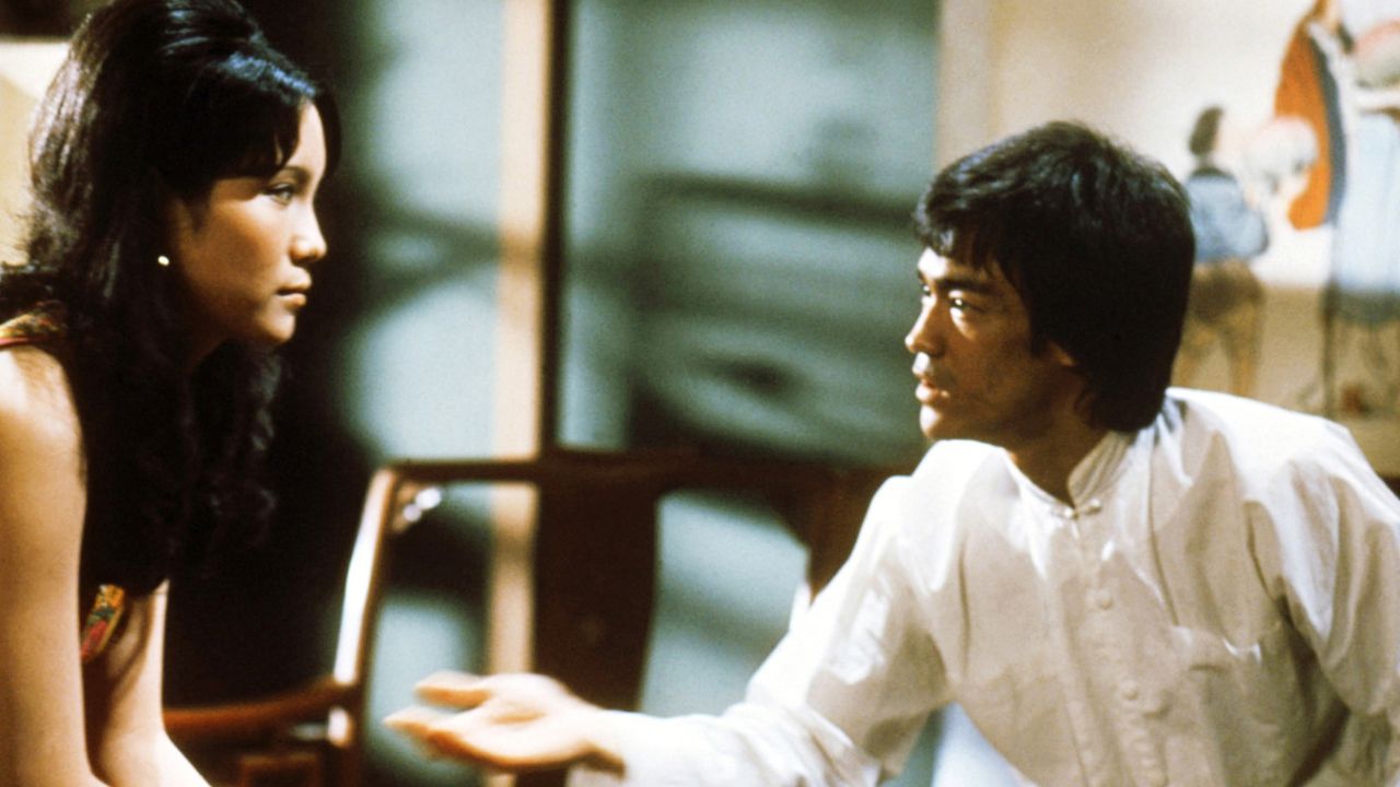 a woman and Bruce Lee talking